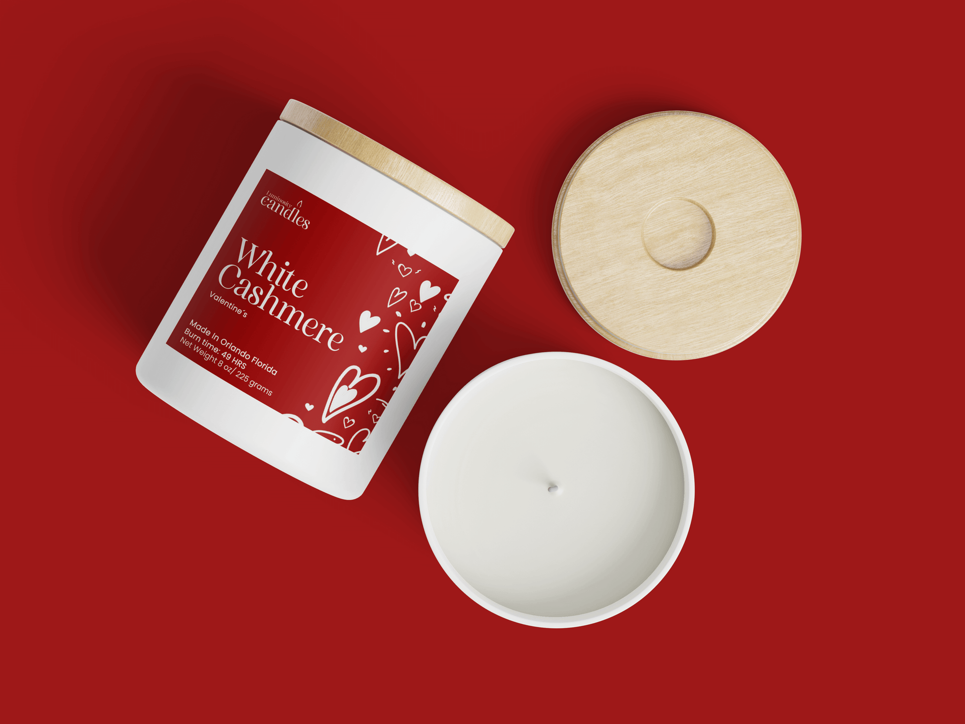 White Cashmere candle with a wooden lid on a red background, showcasing its soft fragrance and elegant design.